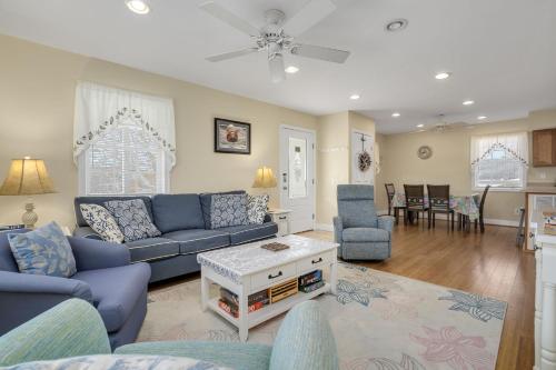 a living room with a blue couch and chairs at Beach Haven - Modern Home; Close to town! in Chincoteague