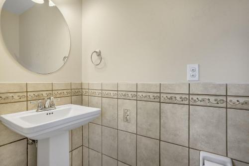 a bathroom with a sink and a mirror at Beach Haven - Modern Home; Close to town! in Chincoteague