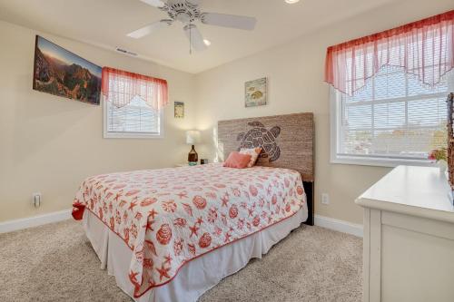 a bedroom with a bed and two windows at Beach Haven - Modern Home; Close to town! in Chincoteague