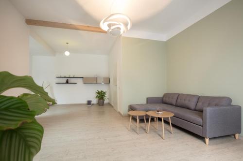 a living room with a couch and a table at Ferienwohnung Naturzeit Lauscha in Lauscha - Ernsthal am Rennsteig