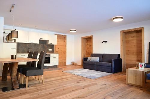 a kitchen and living room with a table and a couch at Apartment Grubigstein in Biberwier