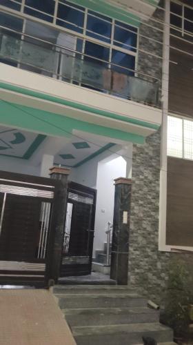 an entrance to a building with doors and a balcony at home stay IIIT chauraha near subedargunj railway station in Prayagraj