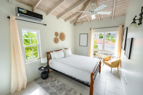 a bedroom with a bed and a window at Sweet Home Grenada Caribbean in Lance aux Épines