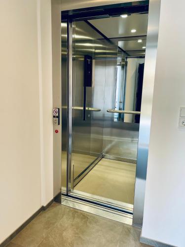 an elevator in a building with a glass door at Ferienwohnungen Lukaserhof in Mieming