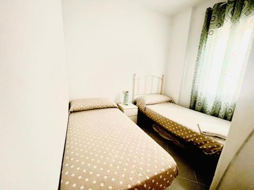 Letto o letti in una camera di PISO CENTRO HISTÓRICO 3 DORMITORIOS