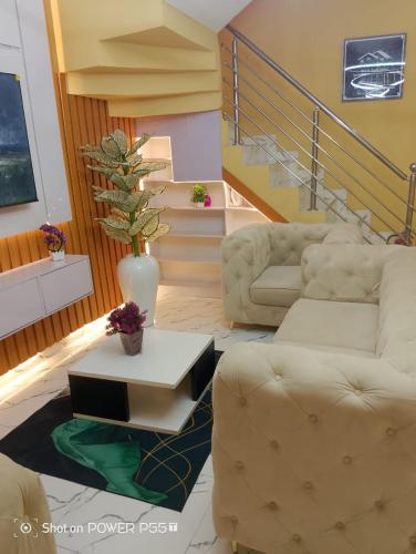 a living room with a couch and a table at Rich Garden Homes Shortlet Apartment in Ikota