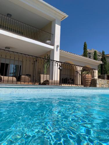 a swimming pool in front of a house at Clos des Oliviers in Lumio