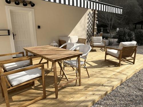 a wooden table and chairs on a wooden deck at GURAH Boutique Apartments in Bakio