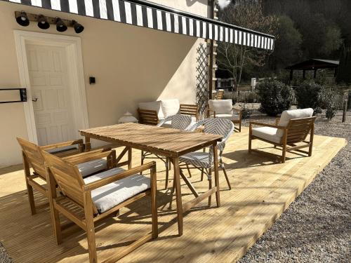 a wooden table and chairs on a wooden deck at GURAH Boutique Apartments in Bakio