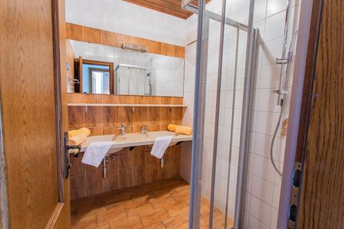 a bathroom with a sink and a mirror at Huberhof 9 by Alpenidyll Apartments in Rohrmoos