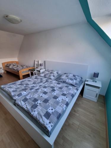 a bedroom with a bed with a blue and white comforter at Ferienhaus 1260 in Tossens in Tossenserdeich