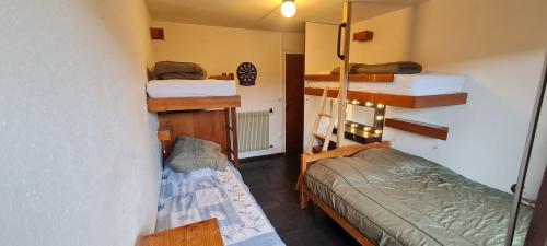 une chambre avec deux lits superposés et un lit dans l'établissement Murat-le-Quaire Appartement meublé classé 2 étoiles, à Murat-le-Quaire