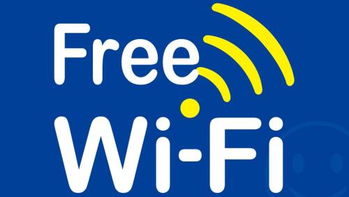 a sign with the free wifi logo on a blue background at Hotel Arashi Shinsaibashi No001 in Osaka
