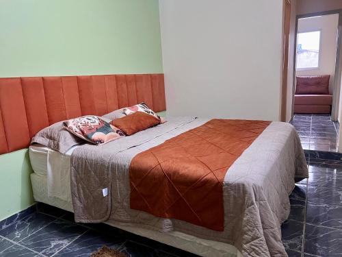 a bed with a person laying on it in a room at Casa Naza in Areia