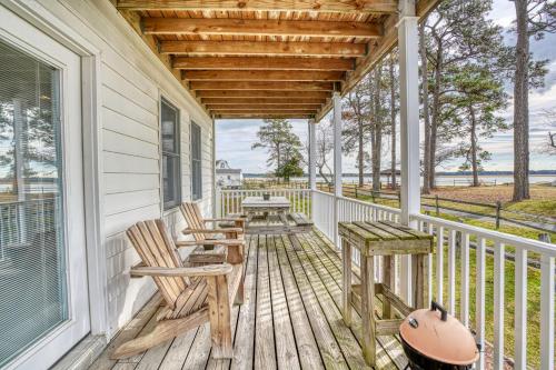 a porch with chairs and a table on a house at Channel Lookout - Water views & public dock! in Black Point Landing