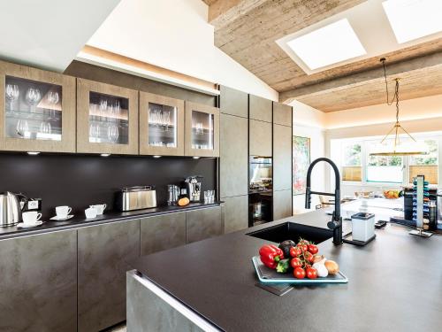a kitchen with a counter with a plate of vegetables on it at FeWo Prora - Stella Maris Dachterrasse in Binz