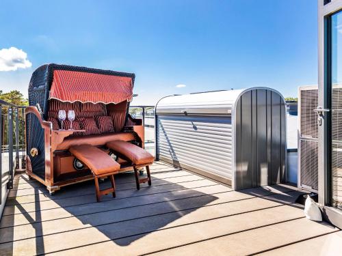 a chair on the deck of a boat at FeWo Prora - Stella Maris Dachterrasse in Binz