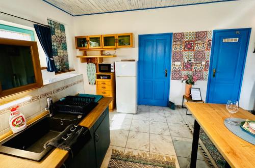 a kitchen with blue doors and a counter top at Apartment Happy Days Szombathely in Szombathely