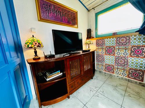 a living room with a television and a window at Apartment Happy Days Szombathely in Szombathely