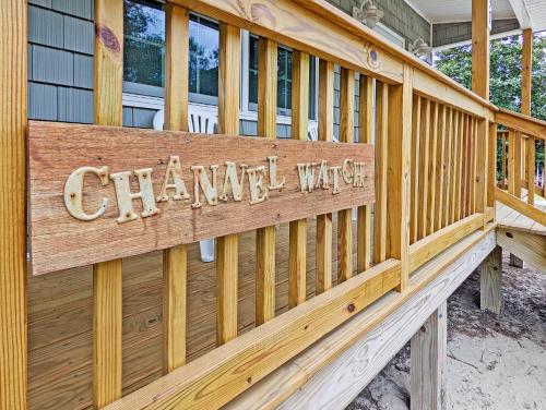 a wooden sign on the side of a house at Channel Watch - Waterfront home with private Pier! in Deep Hole