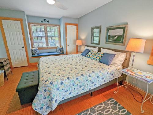a bedroom with a large bed and a table at Channel Watch - Waterfront home with private Pier! in Deep Hole