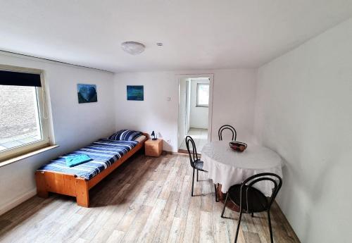 a bedroom with a bed and a table in it at Monteurwohnungen Santos Lerch in Krefeld