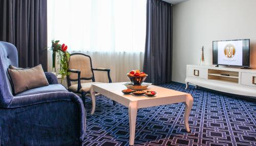 a living room with a couch and a coffee table at Grand Mogador City Center in Casablanca