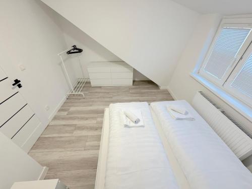 un lit blanc dans une chambre avec une fenêtre dans l'établissement Krásny byt - apartmán 7 v blízkosti centra, à Bratislava
