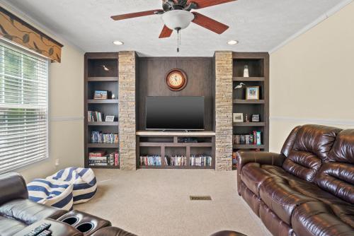 a living room with a couch and a flat screen tv at Charlie's Cove - Pet friendly w/ Fenced yard! in Black Point Landing