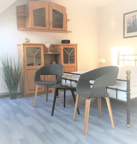 a dining room with two chairs and a table at App 255Haus 6 in Dierhagen