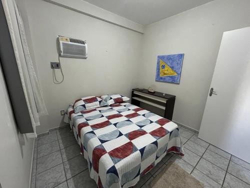 a bedroom with a bed and a air conditioner at Apartamento em Natal-RN in Natal