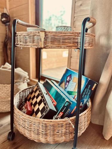 a basket full of books sitting on a floor at ŁAP LAS Wiktorowo in Annowo