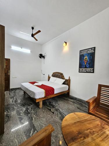 a bedroom with a bed and a ceiling fan at Lake facing Villa-Water sport activities-Niva Waterways in Vaikom