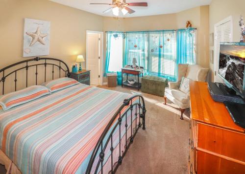 a bedroom with a bed and a living room at Cockleshell Cottage - Pet friendly & Handicap Accessible! in Deep Hole