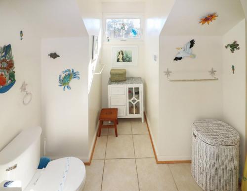 a bathroom with a toilet and a sink at Cockleshell Cottage - Pet friendly & Handicap Accessible! in Deep Hole