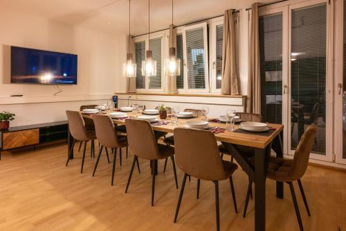 a dining room with a large wooden table and chairs at Munich Large Apartment 150 qm in top centrally located 1 to 15 guests in Munich