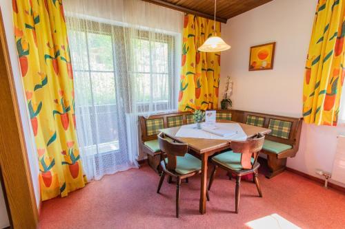 a dining room with a table and chairs at Huberhof 4 by Alpenidyll Apartments in Rohrmoos