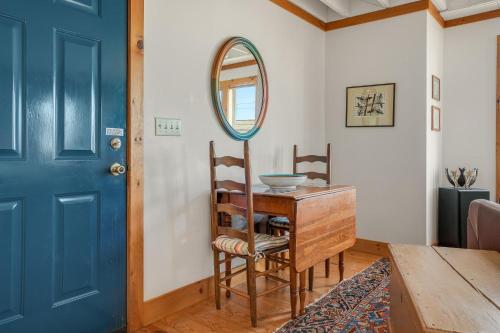 a blue door in a room with a table and a mirror at Cozy Nest - Waterview, Pet Friendly, Screened Porch in Deep Hole