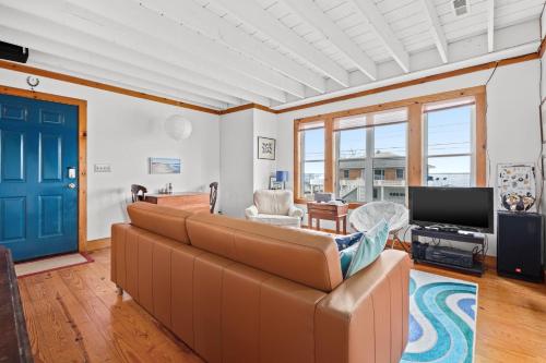 a living room with a couch and a tv at Cozy Nest - Waterview, Pet Friendly, Screened Porch in Deep Hole