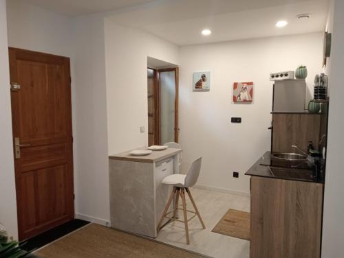 a kitchen with a counter and a chair in it at Sasha in Brive-la-Gaillarde