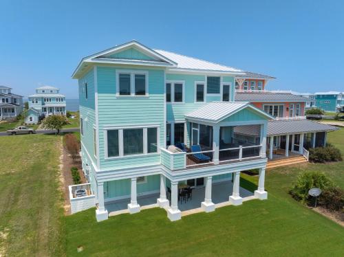an overhead view of a blue house on a lawn at Day Dream Believer - New Construction, Upscale Resort, Many Amenities! in Cape Charles