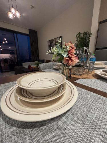 a pile of plates on a table in a living room at Families Only, 1BR Aprt,Beach Access,Garden View in Amwaj Island