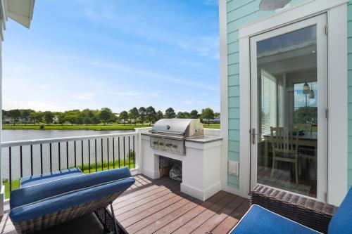 a grill on a deck with a view of the water at Day Dream Believer - New Construction, Upscale Resort, Many Amenities! in Cape Charles