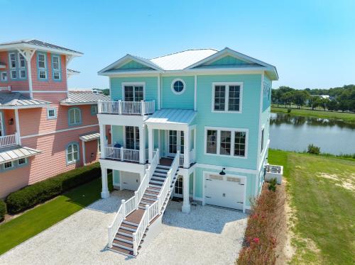 an aerial view of a house with a lake at Day Dream Believer - New Construction, Upscale Resort, Many Amenities! in Cape Charles