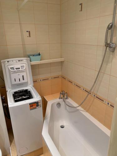 a bathroom with a stove and a bath tub at Your home 10 with parking in Košice