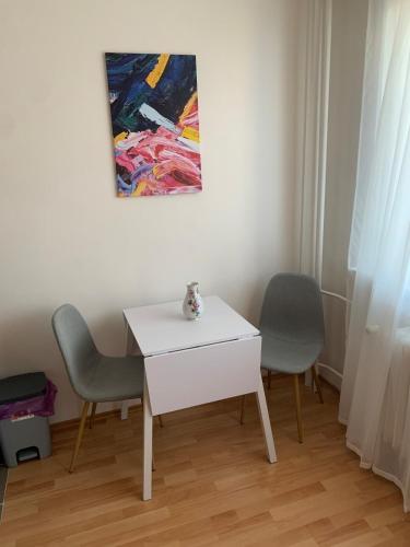 a white table and two chairs in a room at Your home 10 with parking in Košice
