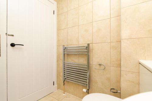 a bathroom with a shower with a white door at 2 Bedroom Flat - Free Parking in Inverurie