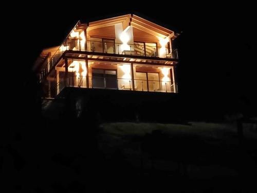 a house lit up at night with lights on it at Klippitz Heights in Klippitztorl
