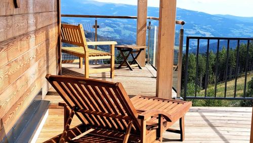 two chairs and a table on a deck with a view at Klippitz Heights in Klippitztorl