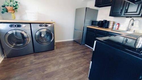 a kitchen with a washing machine and a sink at Private Upstairs Unit near Balt City John Hopkins in Baltimore